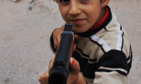 Young Boy Pointing Gun