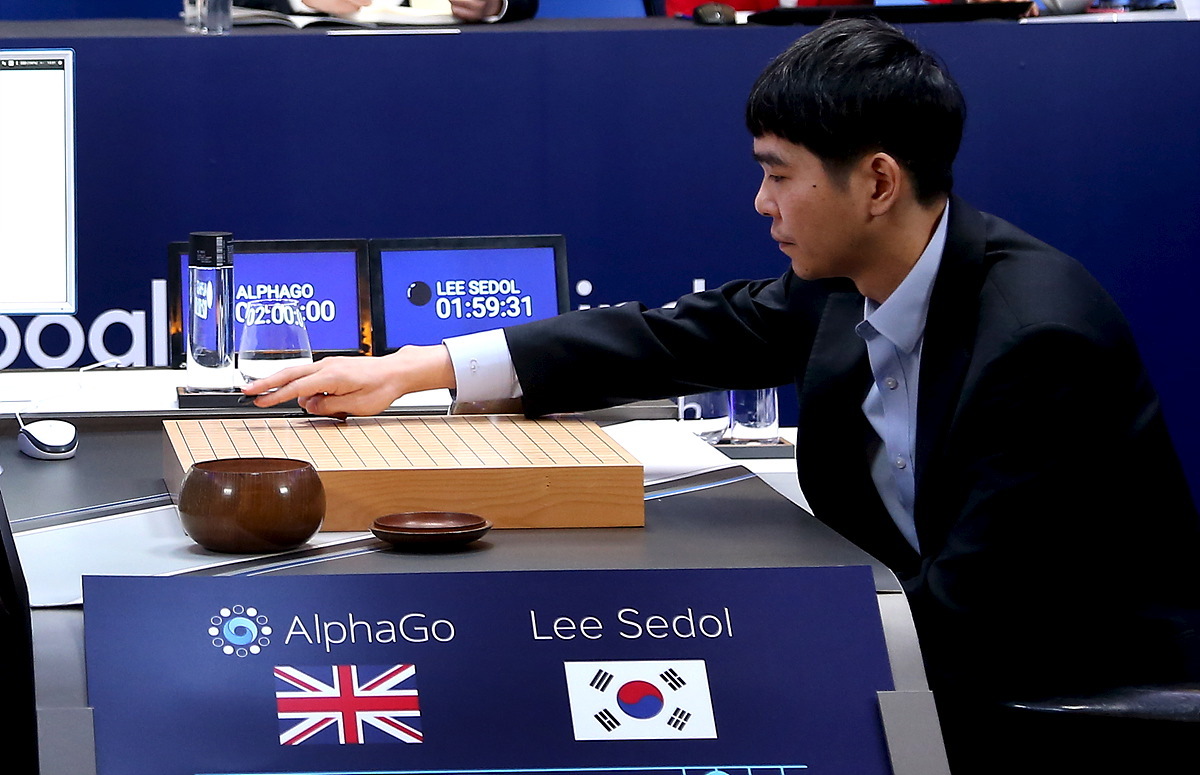 The world's top Go player Lee Sedol puts the first stone against Google's artificial intelligence program AlphaGo during the third match of Google DeepMind Challenge Match in Seoul